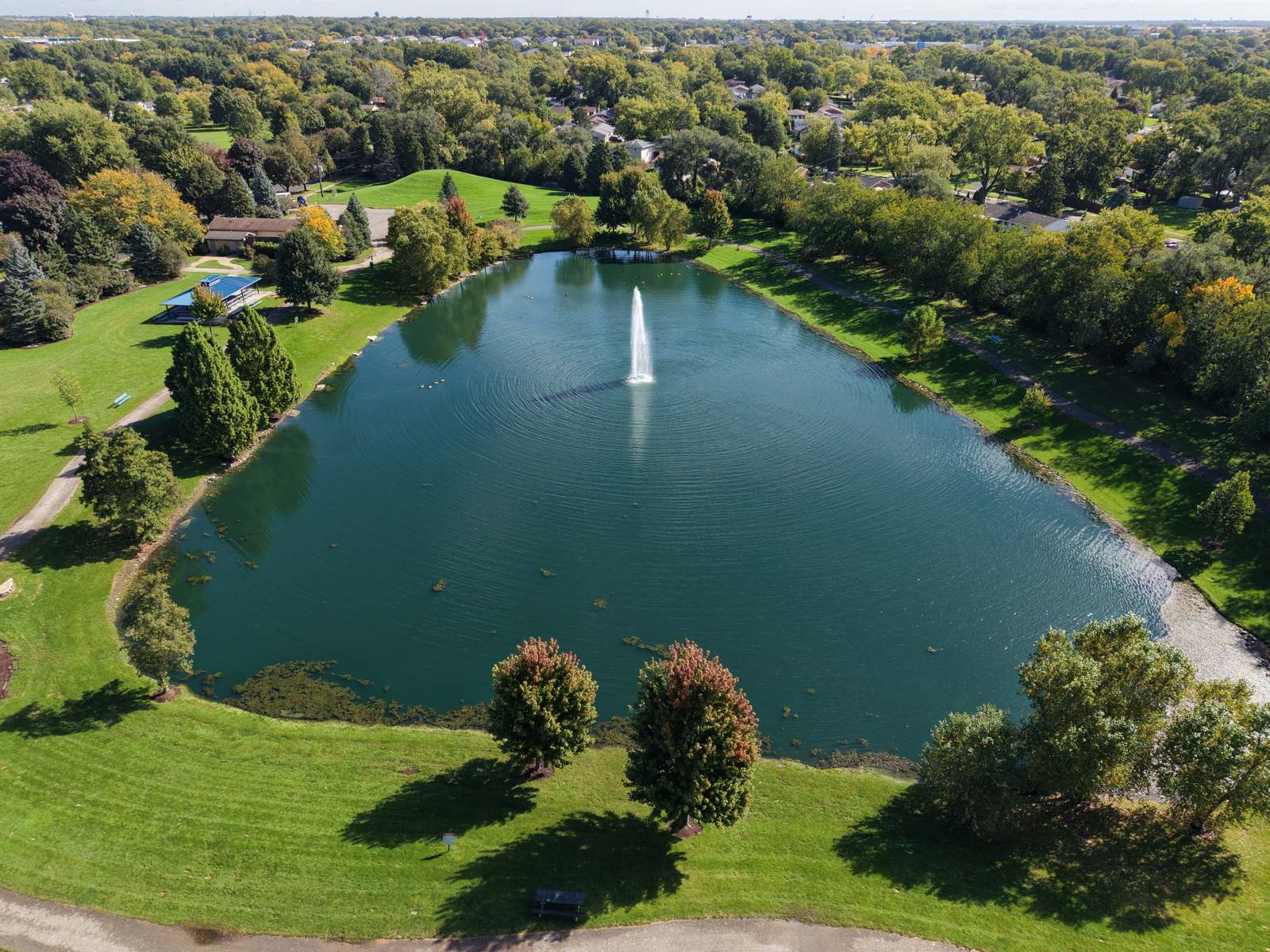 Drone aerial of a park pond and fountain shot by Keithstone Ventures